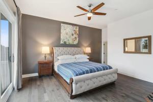 a bedroom with a bed and a ceiling fan at The Burgundy Penthouse Steps to the French Quarter in New Orleans