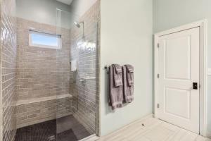 a bathroom with a shower with a glass door at The Burgundy Penthouse Steps to the French Quarter in New Orleans +30 photos
