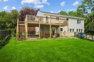 a deck on a house with a yard at Little Creek Retreat - RIBryan Property in Middletown