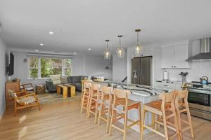 a kitchen and living room with a table and chairs at Little Creek Retreat - RIBryan Property in Middletown
