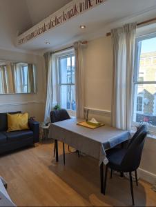 a dining room with a table and two chairs at 2 bed in the Heart of Stoke Newington in London