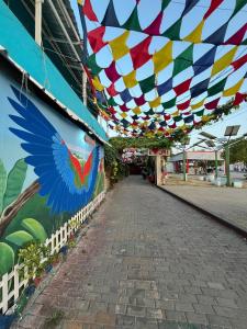 a building with a colorful canopy over a street at Posada Amaripucci in San Andrés
