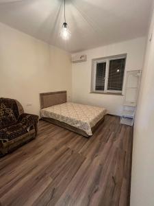 a room with a bed and a chair in it at Sargsyan Guest House in Areni