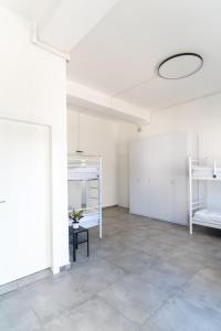 an empty room with white bunk beds and a ceiling at Apartment 34 in Derech Jaffa in Tel Aviv