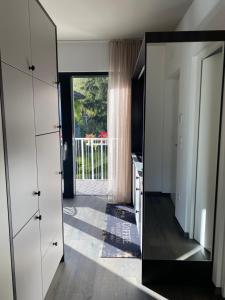 a large mirror in a room with a window at Apartment Villa Huber in Bolzano