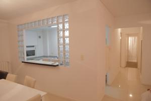 a white room with a mirror on the wall at Pampa Plaza Hotel in Buenos Aires