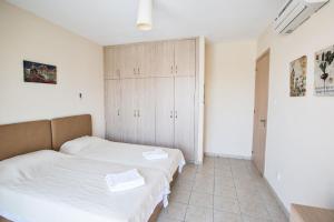 a bedroom with two beds and a closet at Ferienwohnung für 3 Personen ca 1 qm in Agia Napa, Südküste von Zypern - b58979 in Ayia Napa