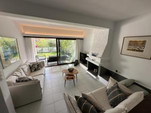 a living room with a couch and a table at Porto Hydra - Villa 44 in Ermioni