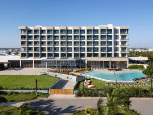 a large hotel with a pool and a resort at Hilton Garden Inn La Romana in La Romana