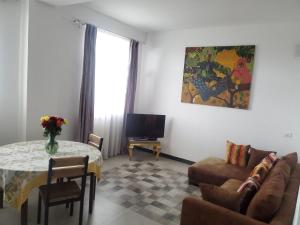 a living room with a couch and a table at YOLE Furnished Apartments in Addis Ababa