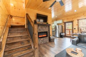 a living room with a fireplace in a log cabin at Hawks Nest Mountain Cabin in Sevierville
