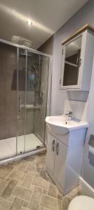 a bathroom with a sink and a shower at 'The Potting Shed' in Knaresborough