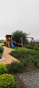 un parque infantil con tobogán y columpio en Luxury Villa, Ocean View, Private Heated Pool en Ferragudo