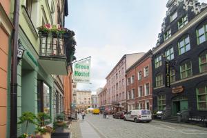 a city street with buildings and a sign for a green hospital at Green Hostel in Toruń