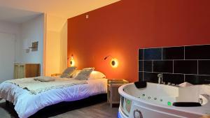a bedroom with a bed and a bath tub at Balnéo Blanche Porte - Arrivée autonome in Tourcoing