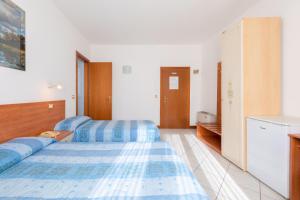 Posteľ alebo postele v izbe v ubytovaní Hotel New Aurora Venice