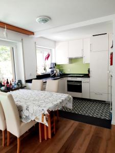 a kitchen with a table and white cabinets at Bodmen 3 Apartments von Privat in Zermatt in Zermatt