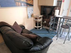 a living room with a leather couch and a table at House Romantic R/C left in Porto