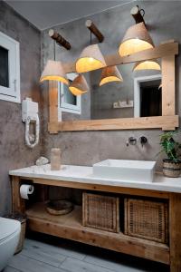 a bathroom with a sink and a mirror at Kanela Studios in Alykes