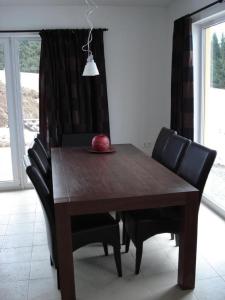 a wooden table with chairs and an apple on it at Ferienhaus für 8 Personen ca 200 qm in Slupecna, Böhmen Moldau in Lipno nad Vltavou