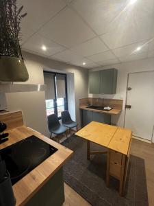 a kitchen with a table and chairs in a room at Agréable Appartement Centre B in Bourges +1 photo