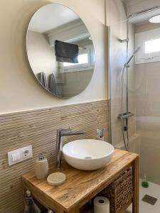 a bathroom with a sink and a mirror at Thegoldsand Cala Salions Tossa de Mar in Girona