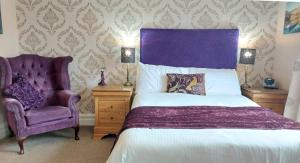a bedroom with a purple bed and a chair at Invergarry Room Only Guest House For Adults in Windermere