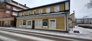 a building on the side of a snowy street at Britz Hostel in Kristinehamn