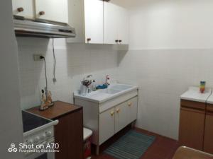 a small kitchen with a sink and a toilet at casa vacanza Sulmona centro in Sulmona