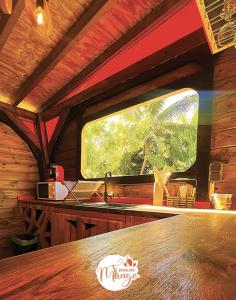 a kitchen with a table and a window in a cabin at Bungalow Ti Koko in Le Gosier