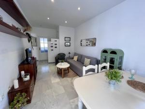 a living room with a couch and a table at Apartamento Empul Costa Sancti Petri in Chiclana de la Frontera