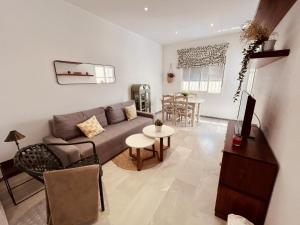 a living room with a couch and a table at Apartamento Empul Costa Sancti Petri in Chiclana de la Frontera