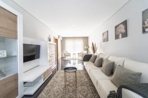 uma sala de estar com um sofá e uma televisão em Casa Eido Doce by House and People em Barcelos