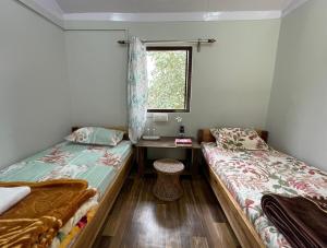 Säng eller sängar i ett rum på Pakha Dhim Homestay Namchi