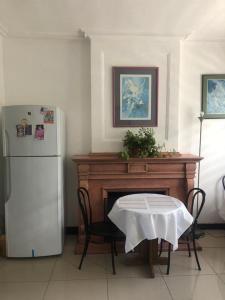a kitchen with a table and a refrigerator at San Sebastian in Concepción