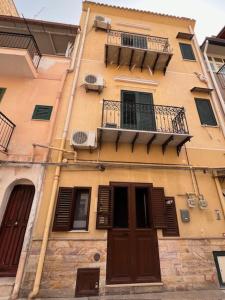 a tall building with windows and a balcony at L'Aurora in Porticello