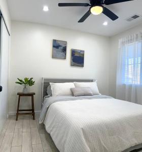a bedroom with a bed and a ceiling fan at Casa Malia -salt water oasis in Desert Hot Springs