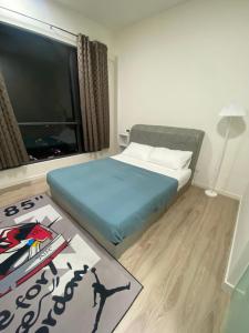 a bedroom with a bed and a large window at Homestay in Cheras