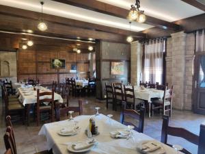 a dining room with tables and chairs in a restaurant at DIMAL CASTLE in Poshnje