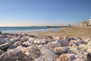 une pile de rochers sur une plage près de l'océan dans l'établissement T2 Label Plage Piscine Climatisation Proche Mer Palavas, à Palavas-les-Flots
