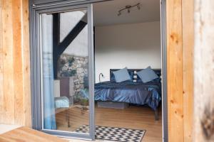 a bedroom with a bed and a large glass window at Domaine Evasion in Ittlenheim