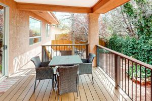 a patio with a table and chairs on a deck at Sedona Sunbeam in Sedona