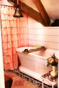 a white bath tub in a bathroom with a shower at Its Day One I Do Bridal Dressing Suite in Nassau