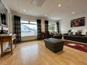 a large living room with a couch and a table at Solway Cottage in Annan