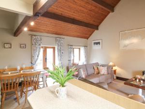 a living room with a couch and a table at Dove Cottage in Leek