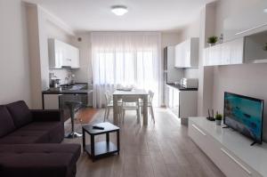 a living room with a couch and a dining room at Novatek Apartment B&B in Chieti