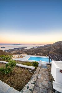 a villa with a pool and a view of the ocean at La Casa del Pastore in Serifos Chora