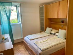 a small bedroom with two beds and a window at Apartment Simon in Bol