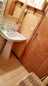 a bathroom with a sink and a mirror at Casa Costa in Tonezza del Cimone