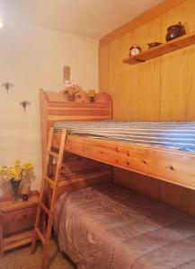 a bedroom with a bunk bed with two shelves at Casa Costa in Tonezza del Cimone